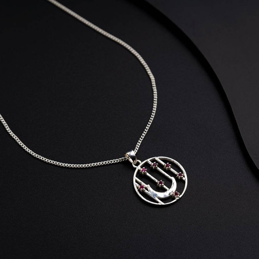 a silver necklace with a letter on it
