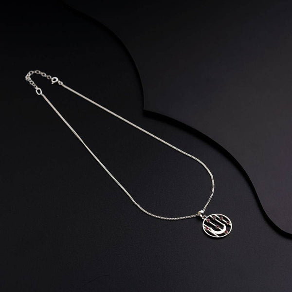 a silver necklace on a black surface
