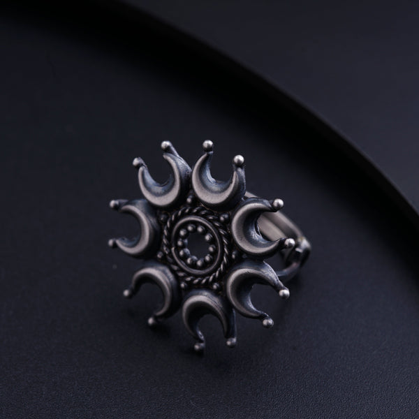 a silver ring with a circular design on it