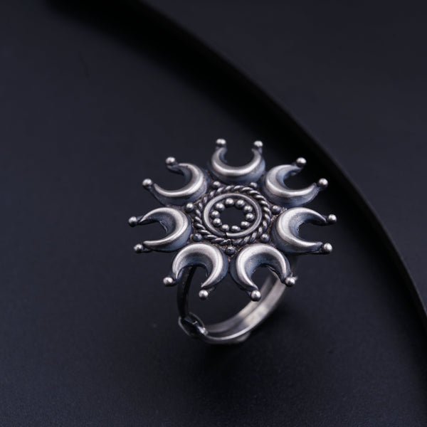a silver ring sitting on top of a black surface