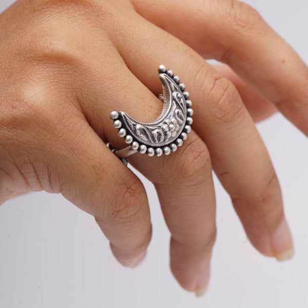 a woman's hand with a silver ring on it