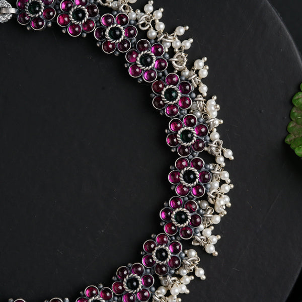 a close up of a necklace on a plate