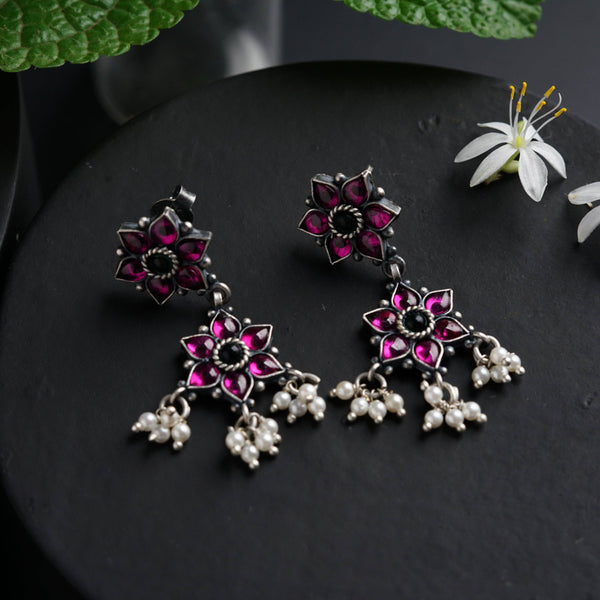 a close up of a pair of earrings on a table