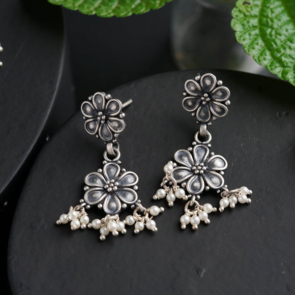 a pair of earrings sitting on top of a table