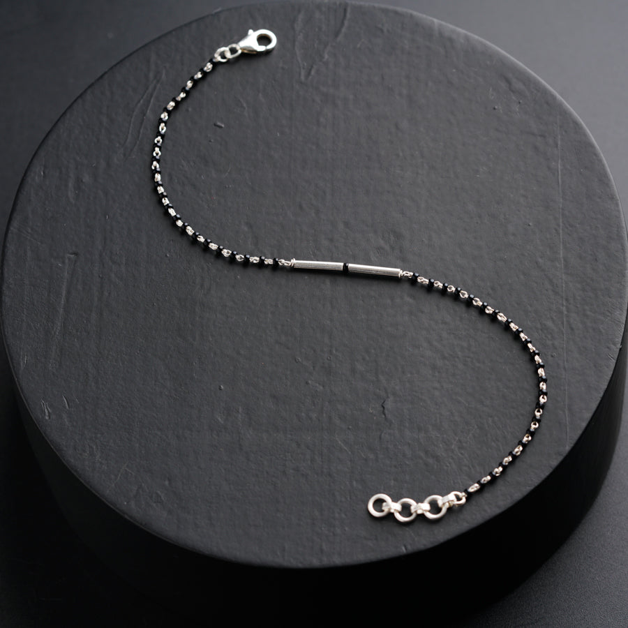 a black beaded necklace with a silver clasp