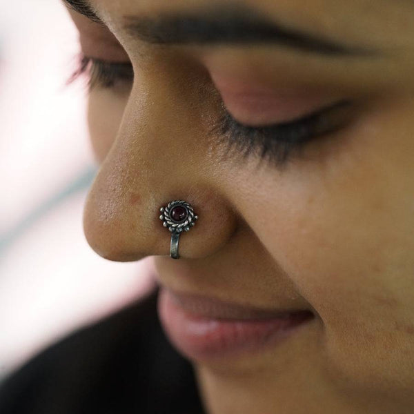 a close up of a person with a nose piercing