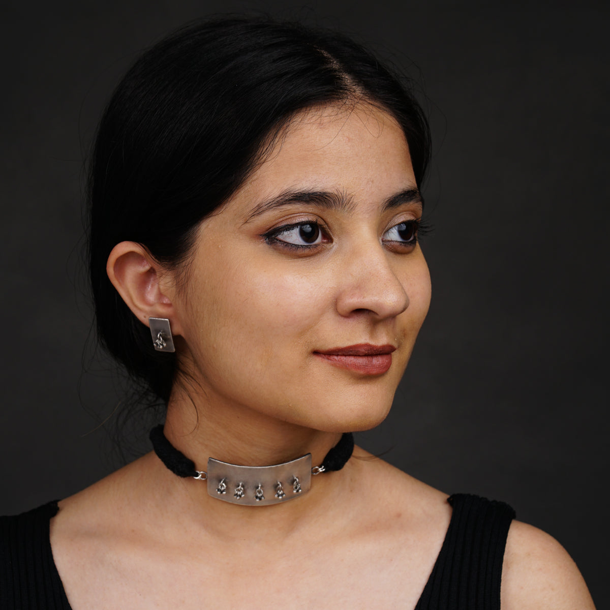 a woman with a choker on her neck