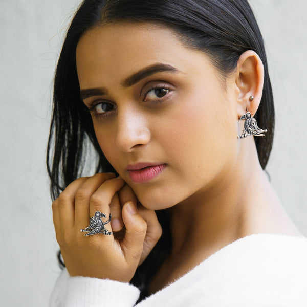 a woman wearing a pair of silver rings