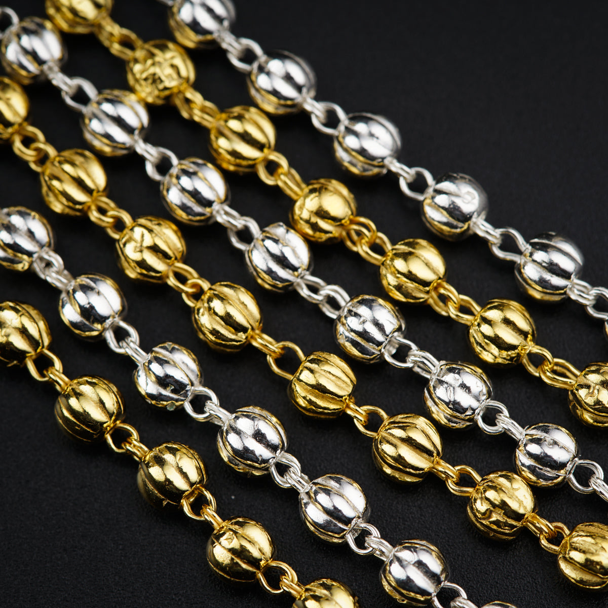 a close up of a chain on a black surface