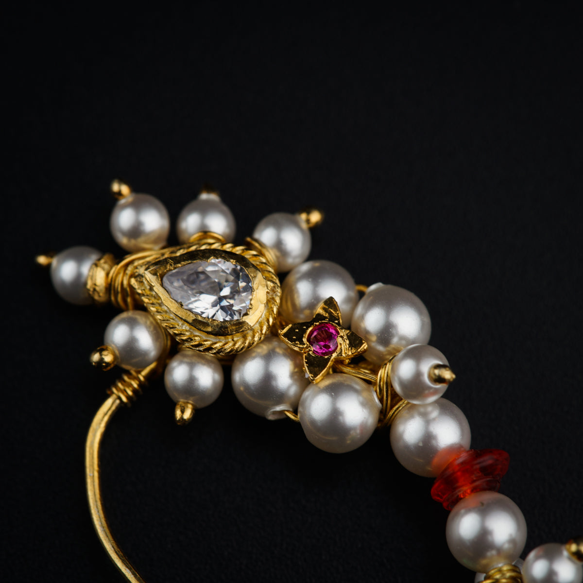 a close up of a bracelet with pearls