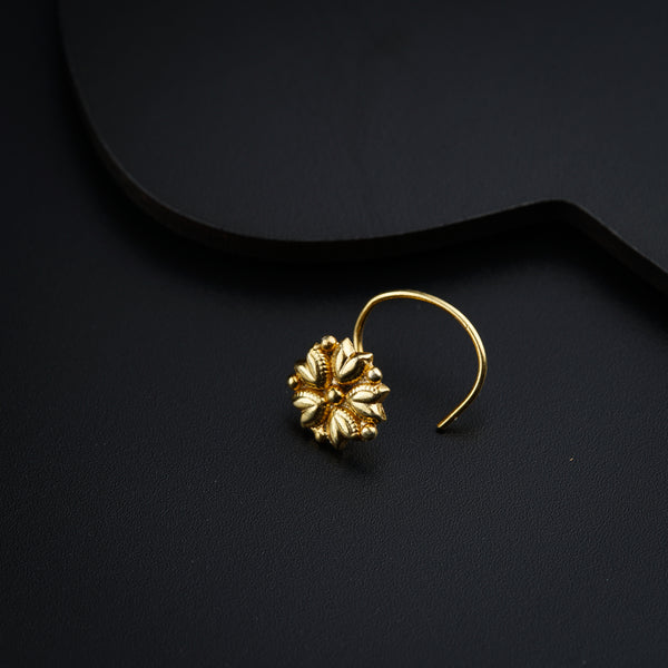 a close up of a pair of earrings on a black surface