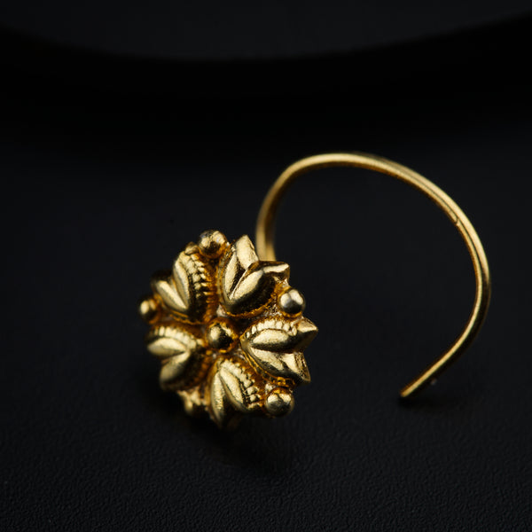 a close up of a pair of earrings on a black surface