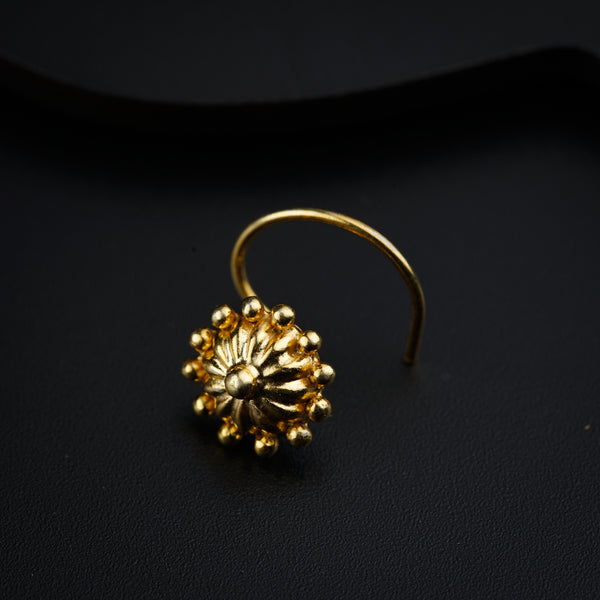 a close up of a gold ring on a black surface