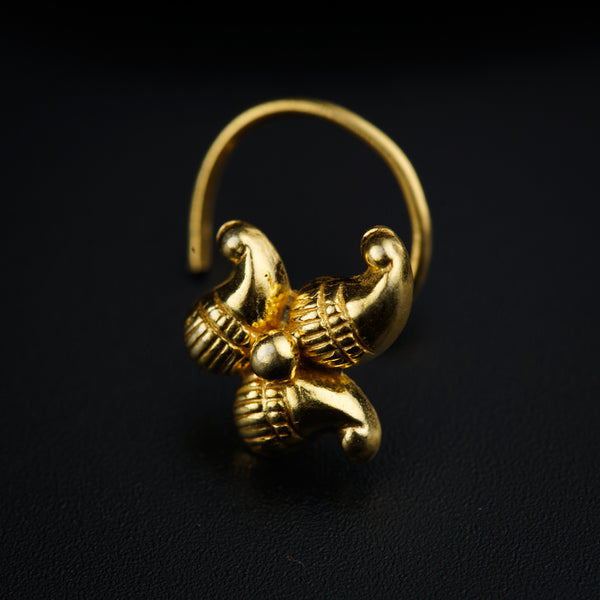 a close up of a gold ring on a black surface