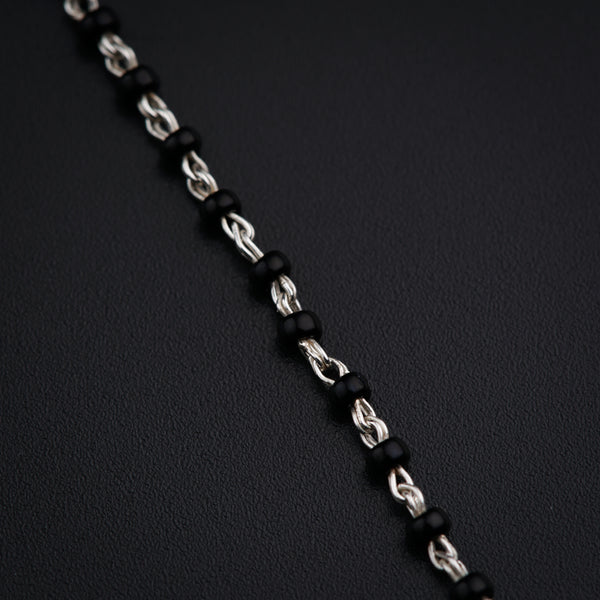 a close up of a chain on a black surface