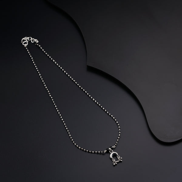 a silver necklace with a skull on it