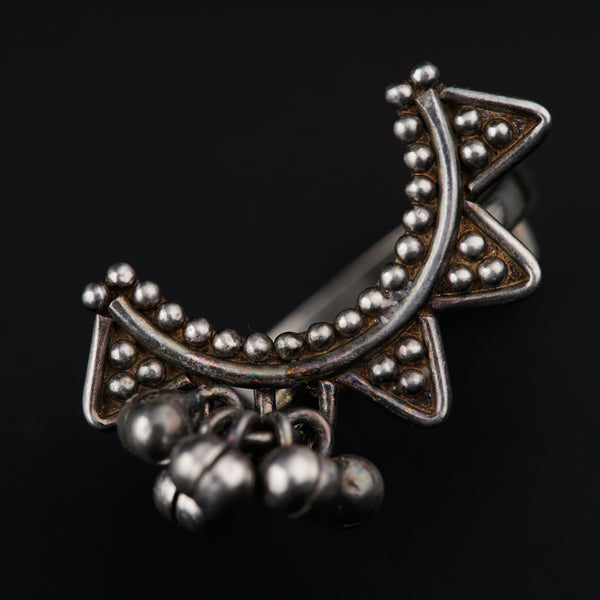 a close up of a metal object on a black background