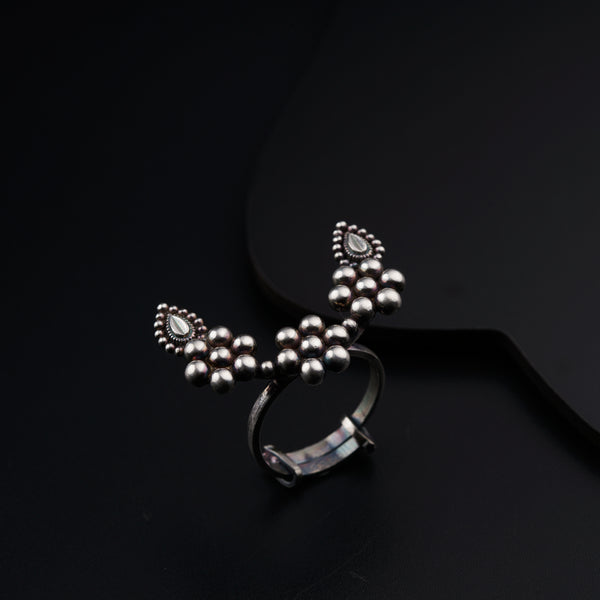 a pair of silver rings sitting on top of a black surface