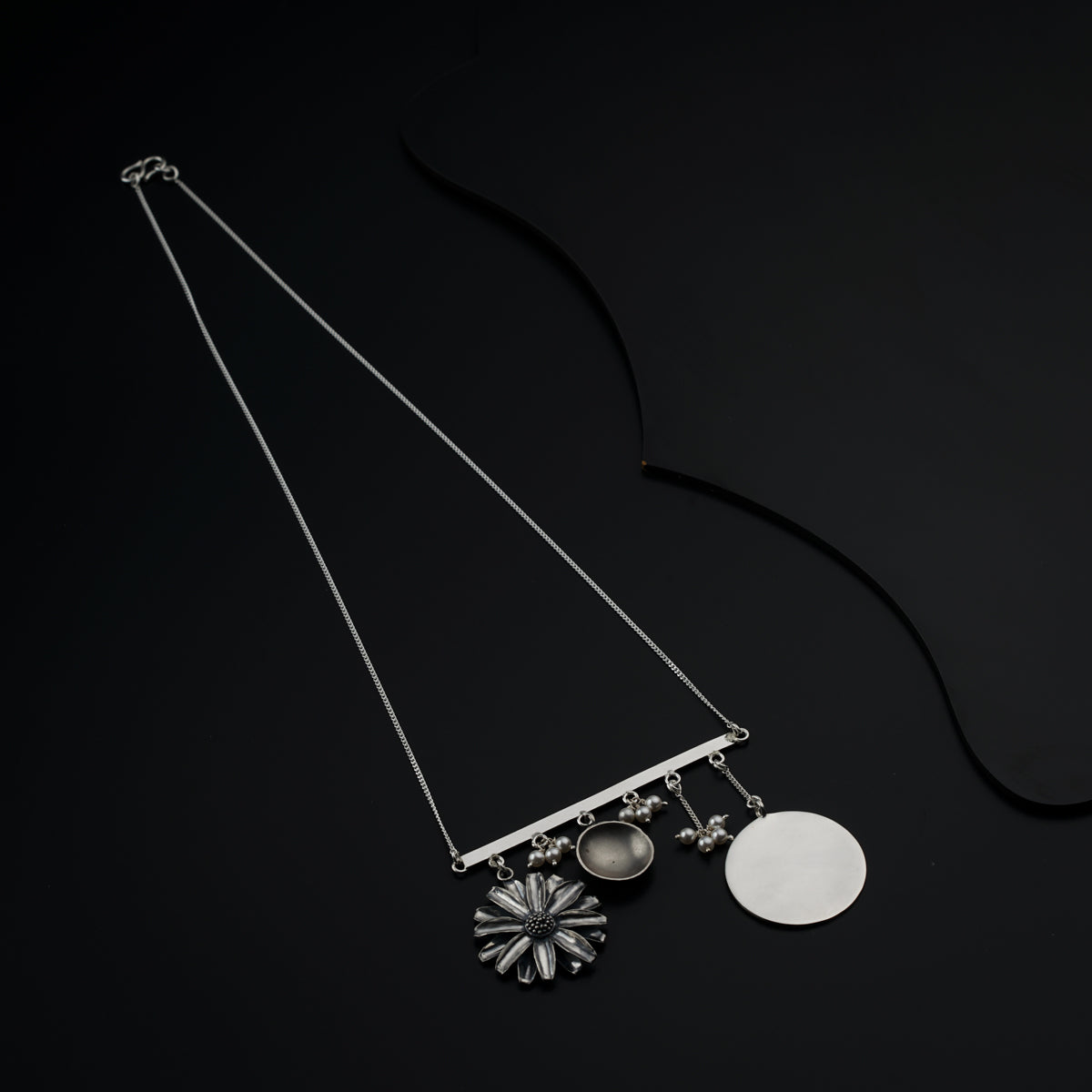 a black background with two necklaces hanging from it's sides