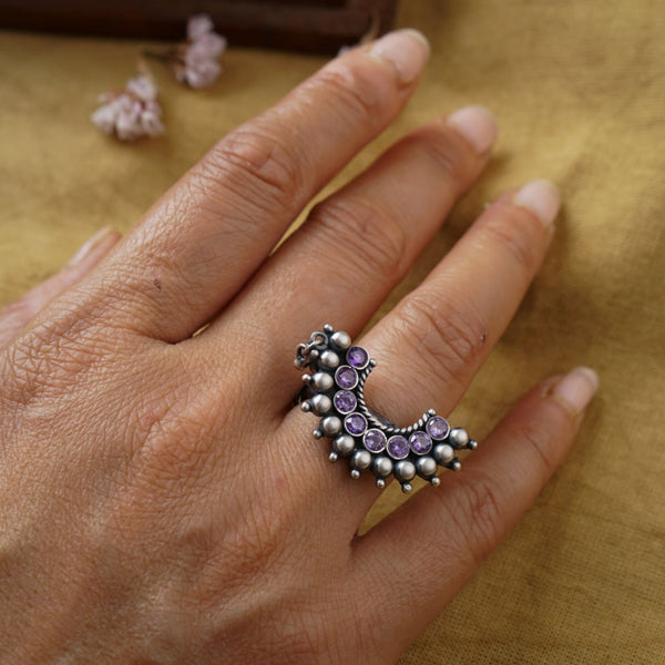a woman's hand with a ring on it