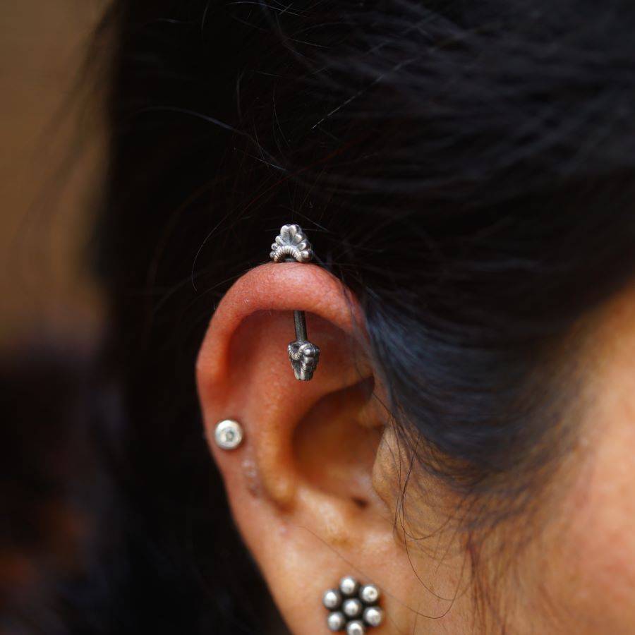 a close up of a person with a ear piercing