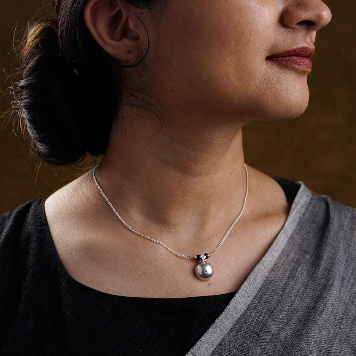 a close up of a woman wearing a necklace