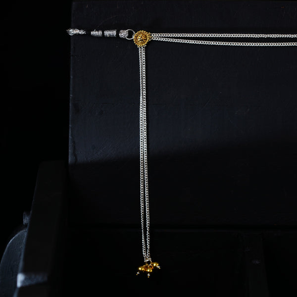 a close up of a necklace on a chair