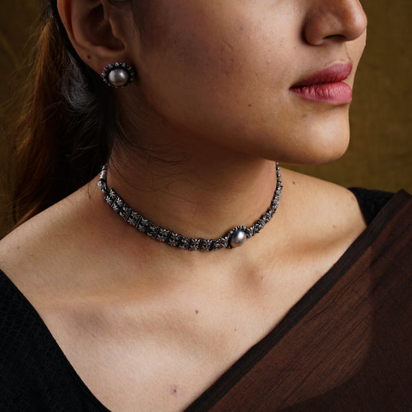 a close up of a woman wearing a necklace