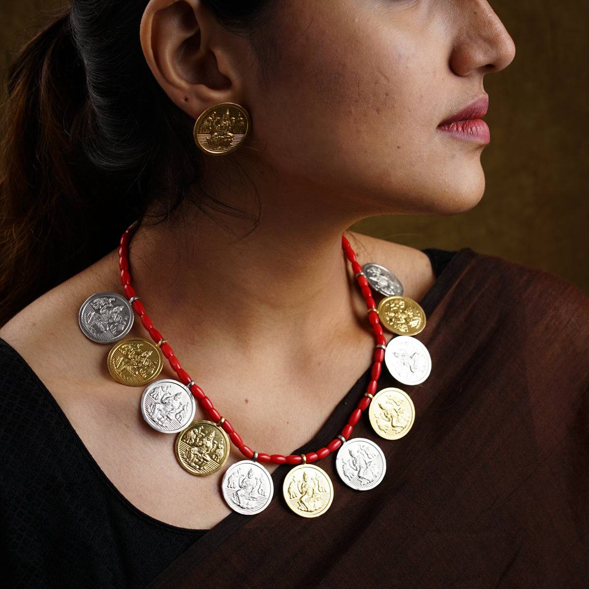 a woman wearing a necklace made of coins