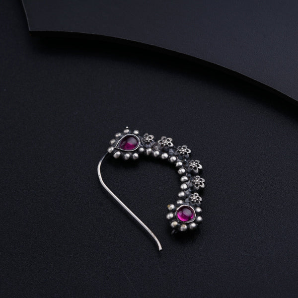 a close up of a brooch on a black surface