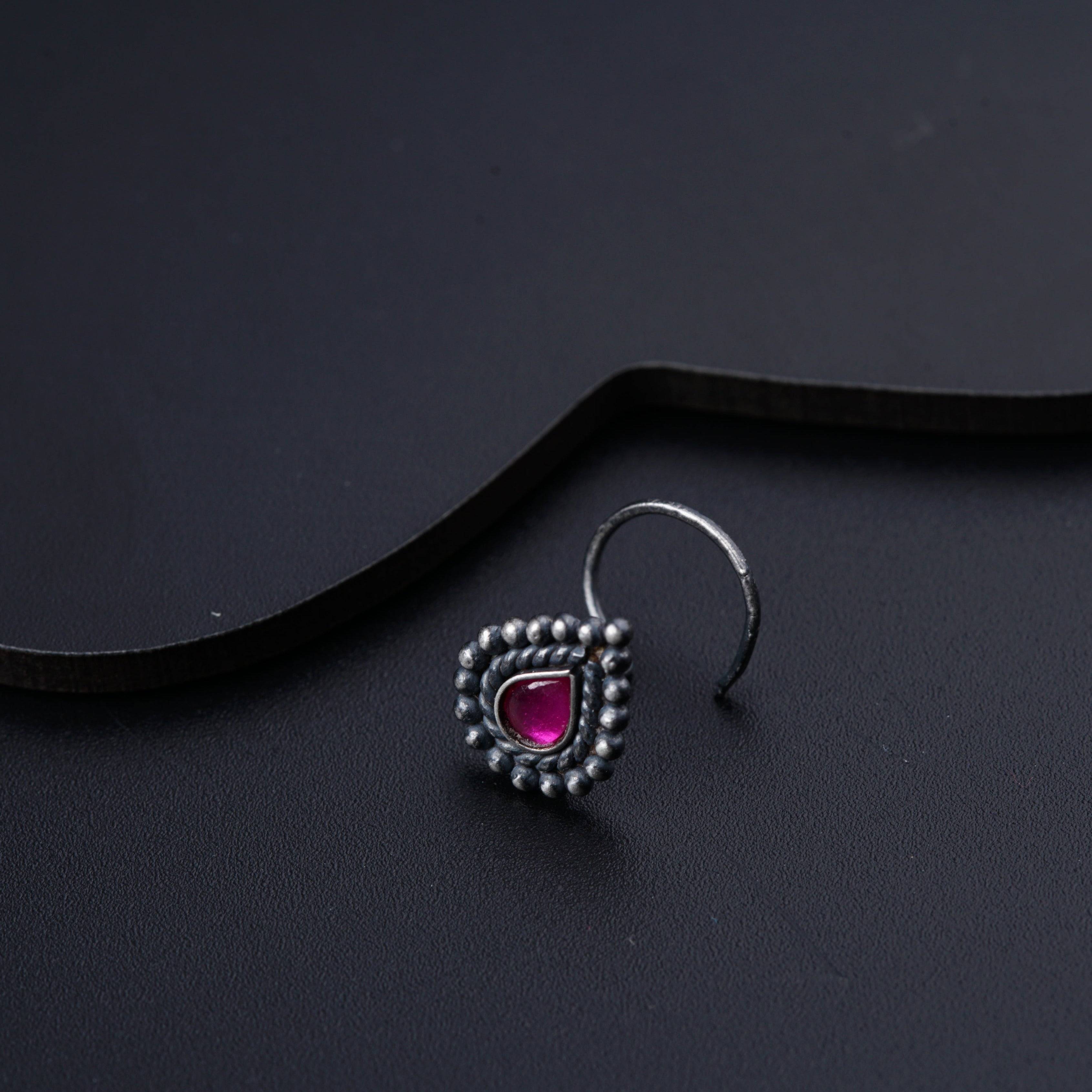 a pair of earrings sitting on top of a table