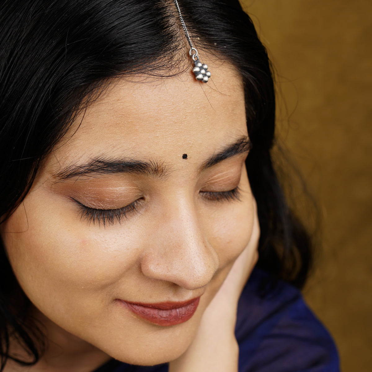 a close up of a person wearing a head piece