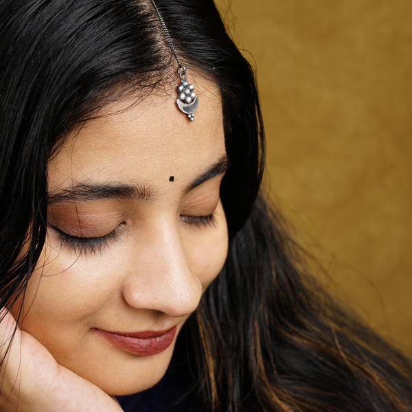 a close up of a woman wearing a head piece
