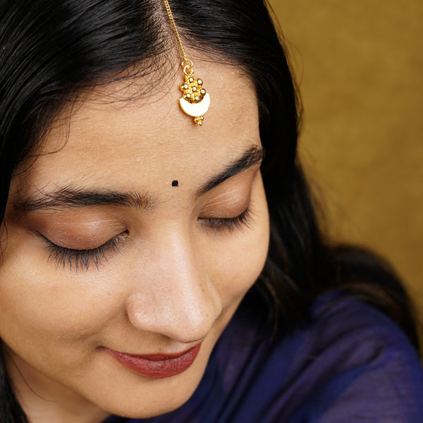 a close up of a person wearing a head piece