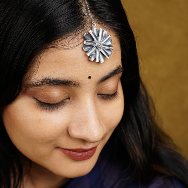 a close up of a woman with a flower in her hair