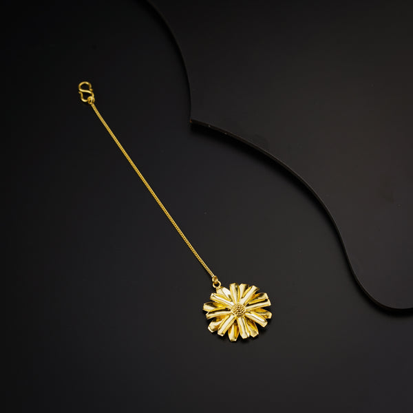 a gold necklace on a black background