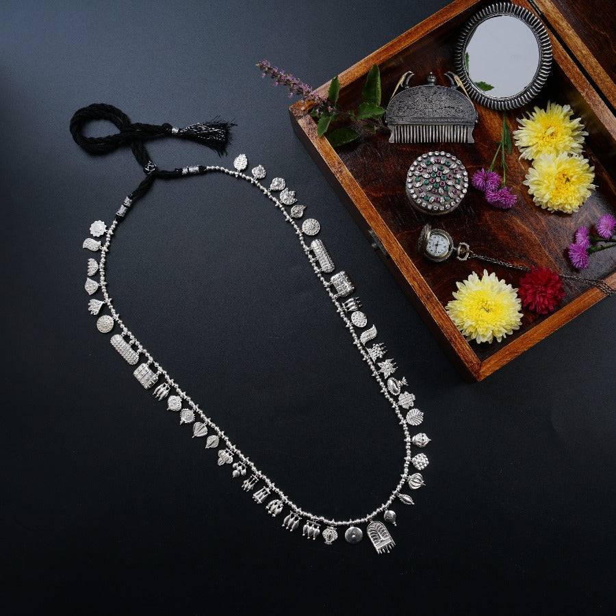 a jewelry box with a necklace and flowers