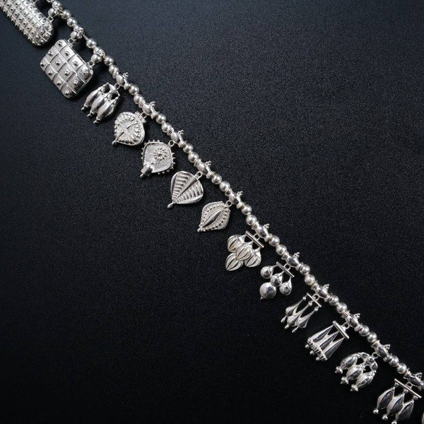 a close up of a bracelet on a black surface