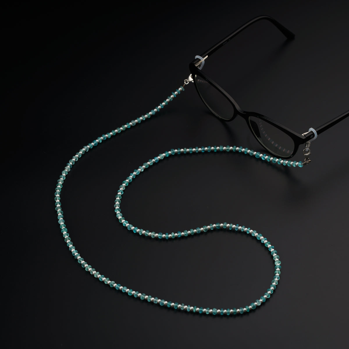 a pair of glasses and a beaded necklace