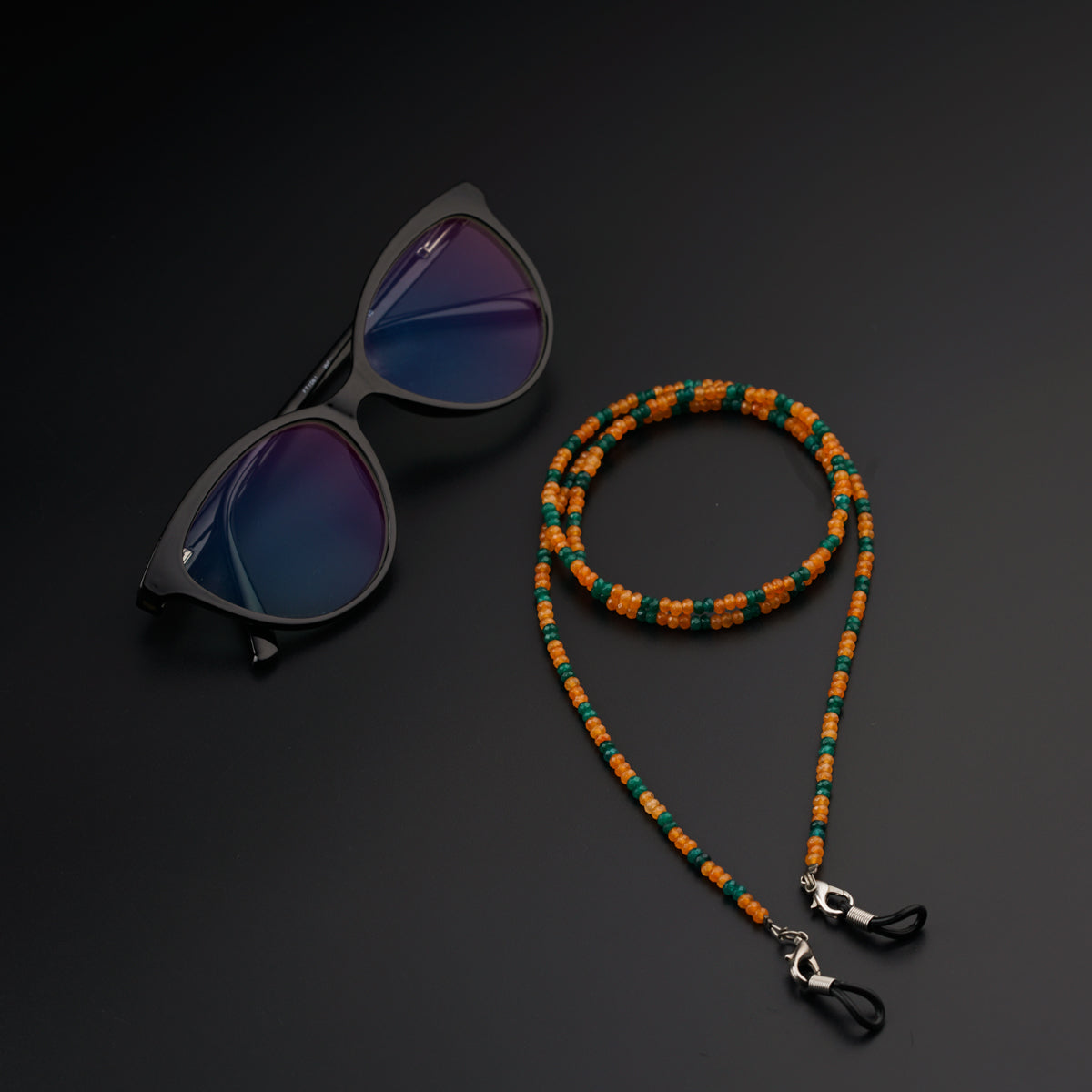 a pair of sunglasses and a beaded lanyard
