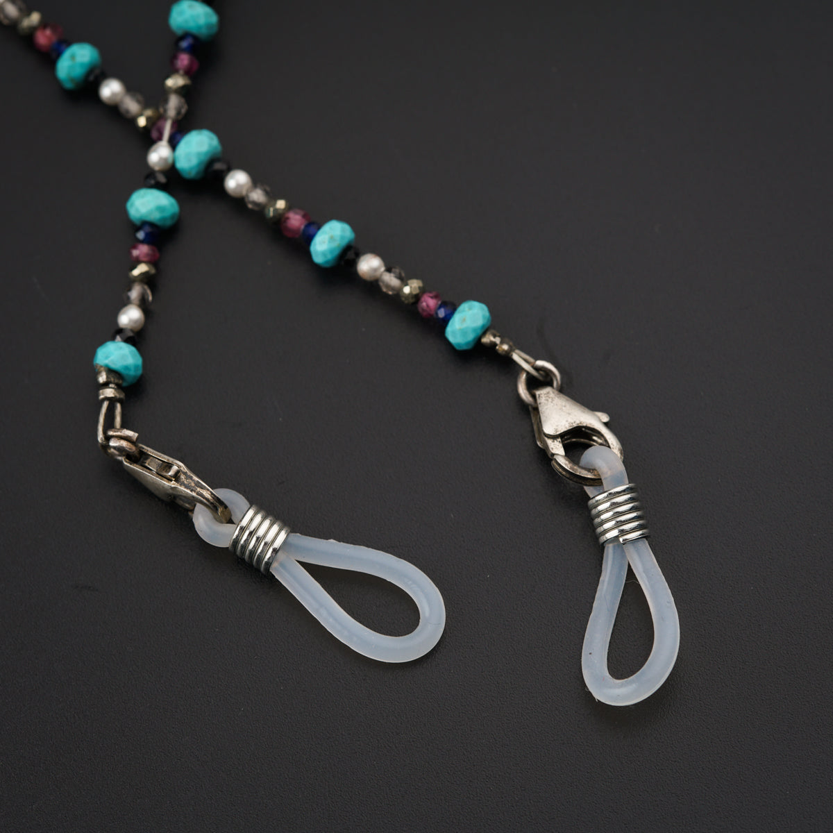 a necklace with beads and a pair of scissors
