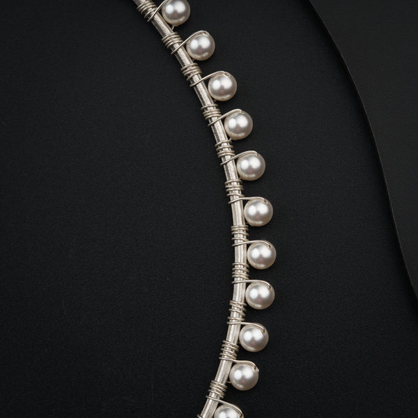 a close up of a necklace on a black surface