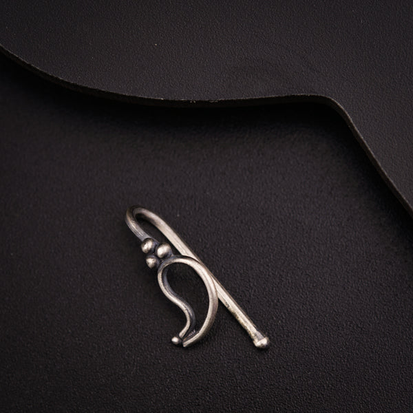 a close up of a metal object on a black surface