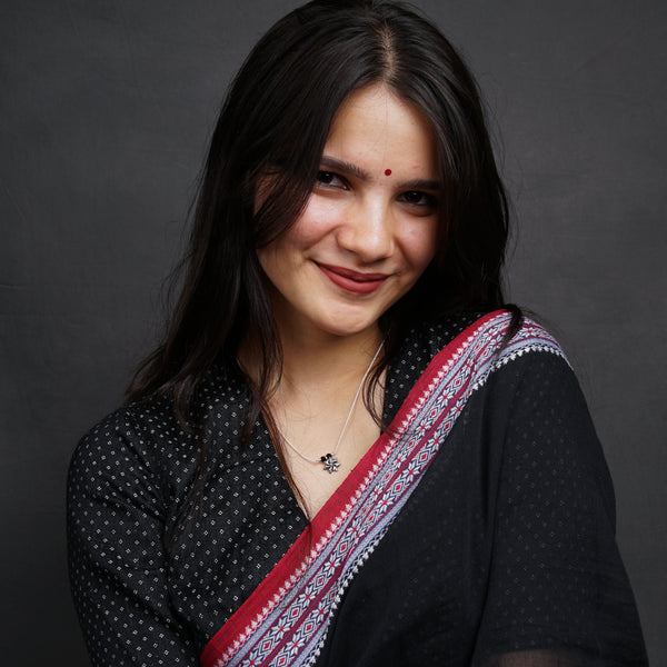 a woman wearing a black shirt and a red and white scarf