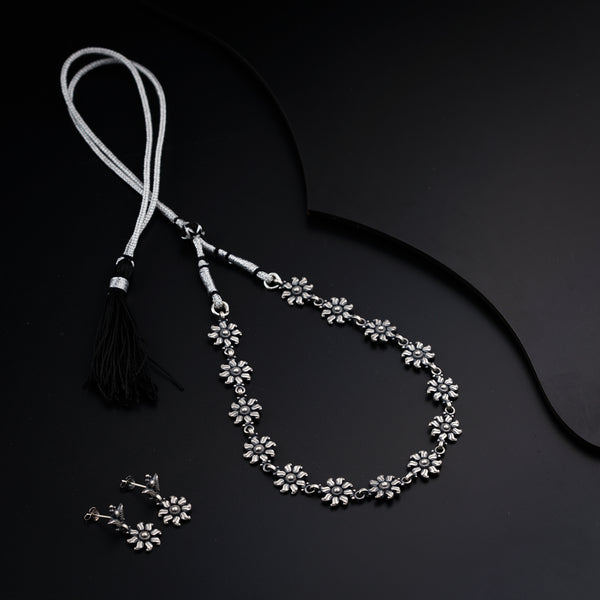 a necklace with a tassel and a pair of earrings