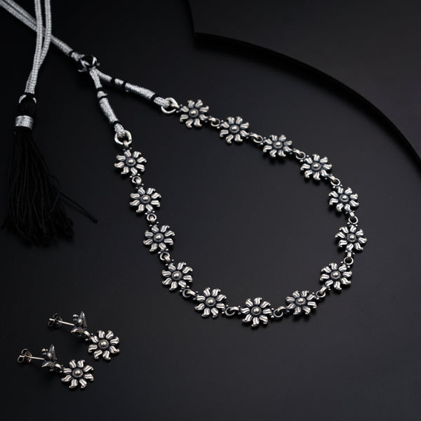 a necklace with a tassel and a pair of earrings