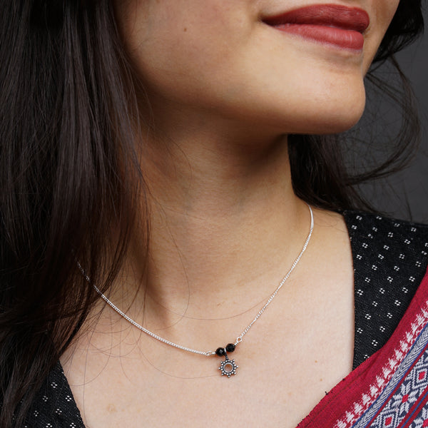 a close up of a woman wearing a necklace