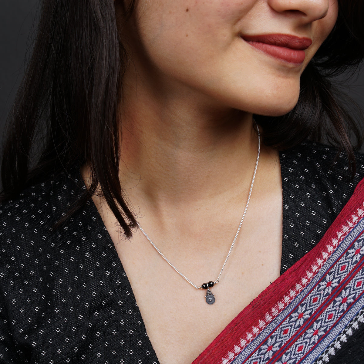 a close up of a woman wearing a necklace