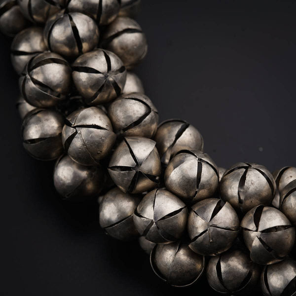 a close up of a metal object on a black surface