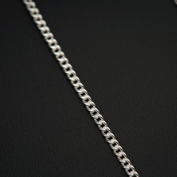 a close up of a chain on a black surface